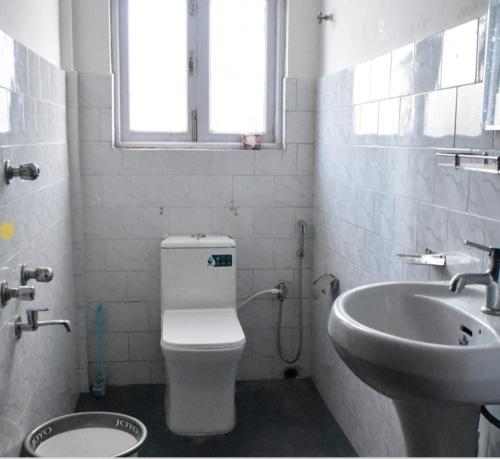 a bathroom with a toilet and a sink at khim Retreat in Mirik