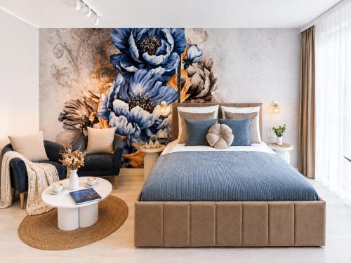 a bedroom with a bed with a blue flower mural at Amber Premium Apartments in Bydgoszcz