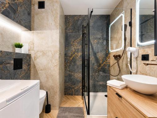 a bathroom with a shower and a sink at Amber Premium Apartments in Bydgoszcz