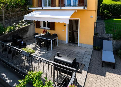 an outdoor patio with a table and an umbrella at Casa Sophie in Consiglio di Rumo