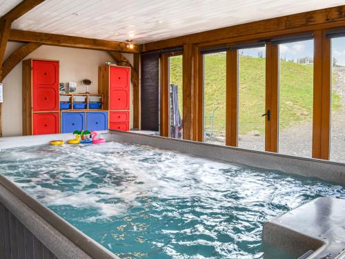 a large hot tub in a house with windows at Ty Nofio - Uk36421 in Talybont