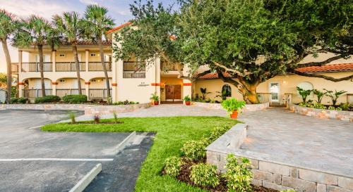 a building with a parking lot in front of it at Inn at Camachee Harbor by CoolVacay in St. Augustine