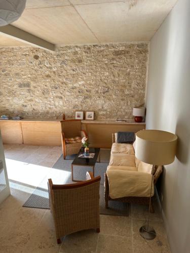 a living room with a couch and a table at Les Foucauds in Saint-Quentin-de-Caplong