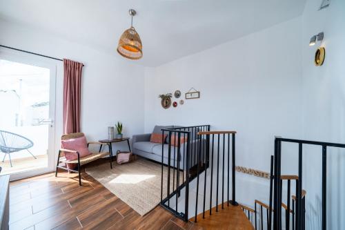 a living room with a couch and a table at Casa do Vento in Aljezur