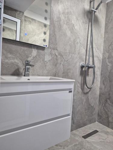 a bathroom with a white sink and a mirror at Silitur Keramoti in Keramoti