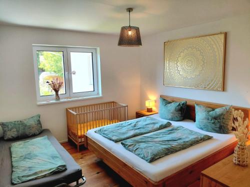a bedroom with a large bed and a window at Kempten mit Bauernhof-Flair in Kempten