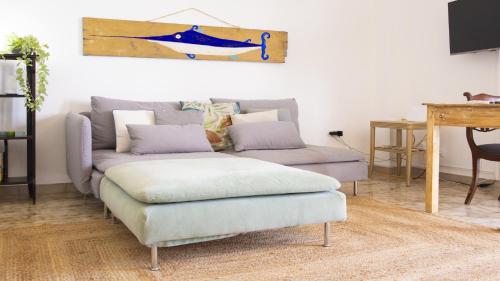 a living room with a couch and a table at Solemar Sicilia - Casa Bella in Bagheria