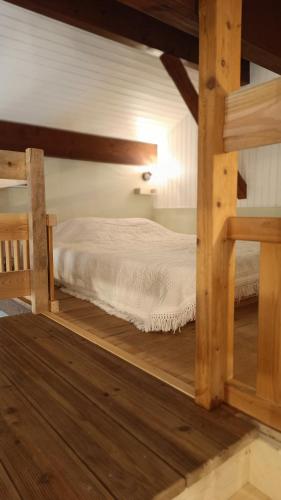 a bedroom with a bed in the attic at Le chalet des paons - Le Mond'idéal in Felon