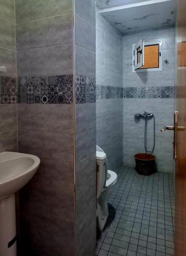 a bathroom with a shower and a toilet and a sink at Casa ahlam in Chefchaouen