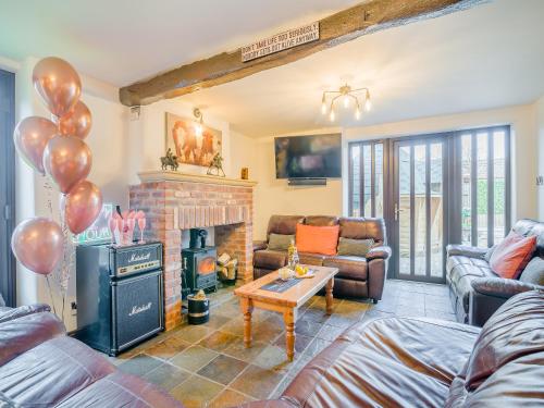 a living room with a fireplace and balloons in it at The Big Old Dairy in Weston-super-Mare