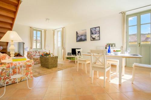 a living room with a table and chairs at Casa Al Prato Apt. F in Varenna