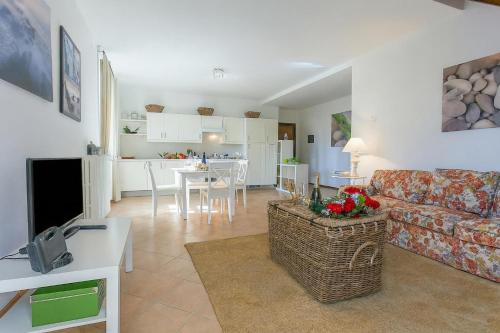 a living room with a couch and a dining room at Casa Al Prato Apt. F in Varenna