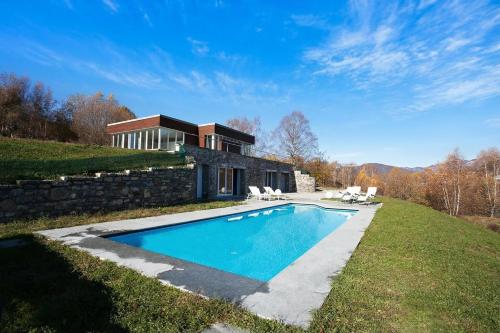 a house on a hill with a swimming pool at Villa La Betulla in Cerano d'Intelvi
