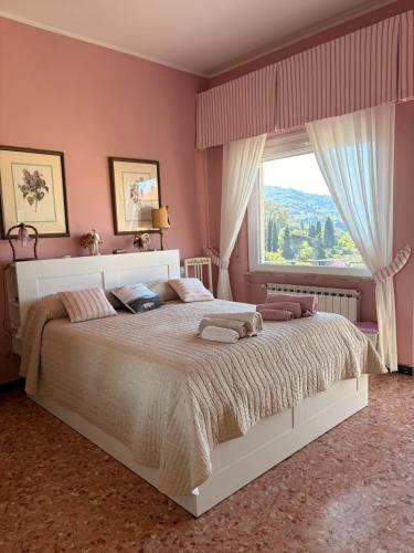 a bedroom with a large bed with a large window at B&b Golfo dei Poeti in Lerici