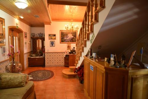 a room with a staircase and a living room at Casa Estrela de Alva in Seia