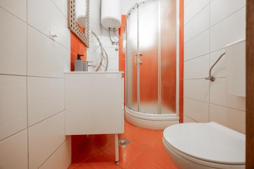 a bathroom with a toilet and a shower at Apartments Villa Rotim in Zadar