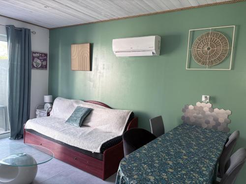 a small room with a bed and a table at Maison une chambre avec jardin in Les Sables-d'Olonne