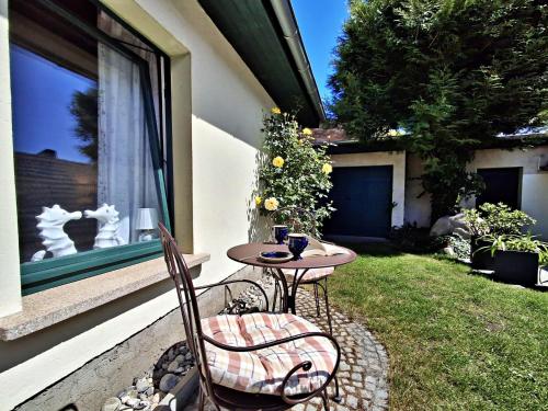 a small table and chairs sitting on a patio at Ferienzimmer Gleißner in Ahlbeck
