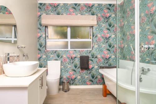 a bathroom with a toilet and a tub and a sink at 36 Alexander Guesthouse,Highlands,Harare in Highlands