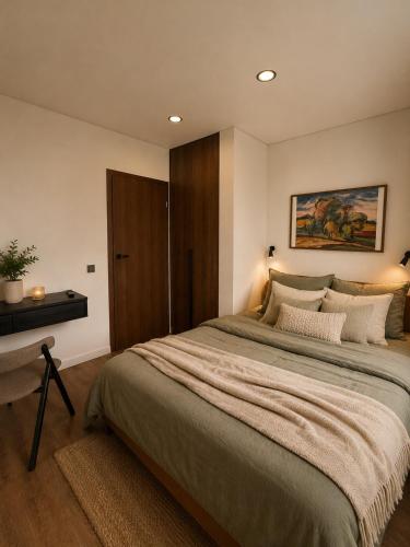 a bedroom with a large bed and a desk at Luxury apartment in Vilnius
