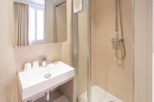 a bathroom with a sink and a shower at Hôtel de France in Monte Carlo