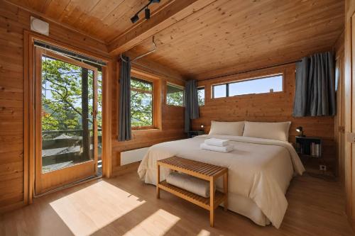 a bedroom with a bed and a large window at Skyline View - Nordic Villa Above Bergen in Bergen