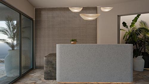 a lobby with a reception desk in a room with plants at Grecale Filoxenia in Vrachonisída touArchangélou