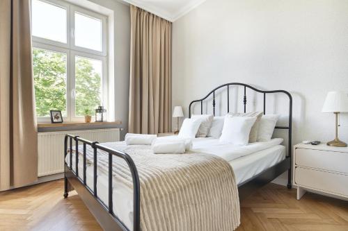 a bedroom with a large bed with white pillows at PlayRoom Aparthotel in Krakow