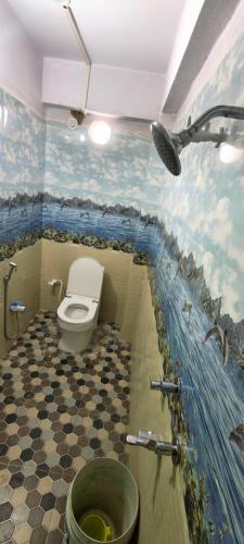 a bathroom with a toilet and a sink in a room at Om Siya Ram Resort in Rājgīr