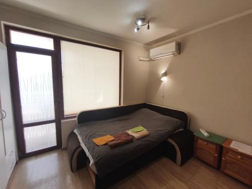 a bedroom with a bed with two towels on it at Apartment in the Center 2 in Varna City
