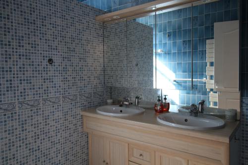 a bathroom with two sinks and a mirror at La Chandeler in Juvigny-sous-Andaine