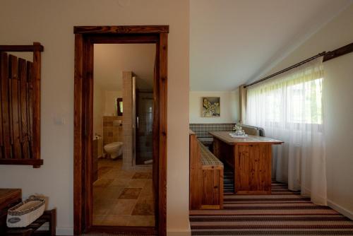 a hallway leading to a bathroom with a sink at Villa Ecaterina in Poiana Negrii