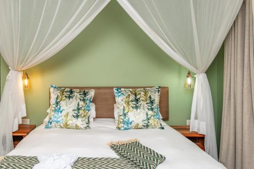 a bedroom with a bed with a canopy at 36 Alexander Guesthouse,Highlands,Harare in Highlands