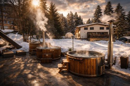 a group of hot tubs sitting in the snow at Chalet Evergreen in Borovets