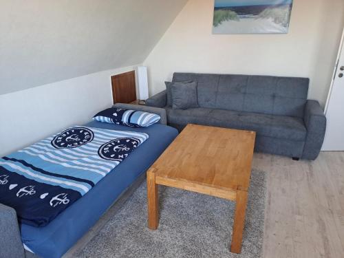 a living room with a couch and a table at FeWo Petersen, Köhn in KÃ¶hn