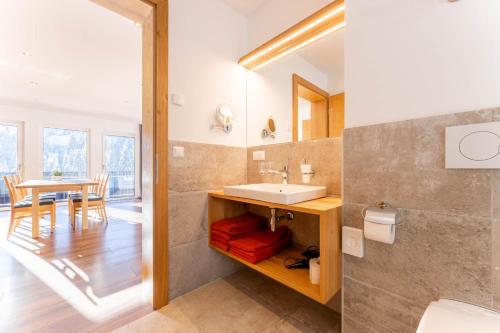a bathroom with a sink and a table at Elisabeth Appartements in Damuls