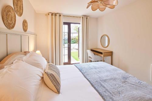 a bedroom with a white bed and a window at Host & Stay - Puffin Cove in Seahouses