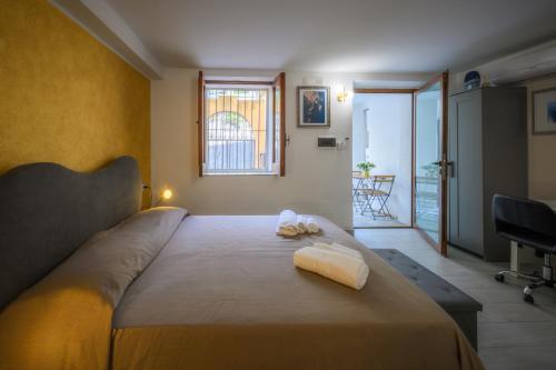 a bedroom with a large bed with two towels on it at La Colombaia Bed and Rooms in Belvedere Marittimo