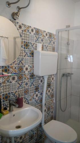 a bathroom with a toilet and a sink and a shower at Studio apartman Marija 2 in Bol