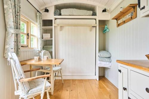 a kitchen with a table and chairs in a tiny house at Host & Stay - Shepherds Delight in Alburgh