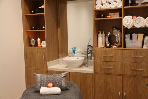 a bathroom with a sink and a counter with a pillow at Belgrave Sands Hotel & Spa in Torquay