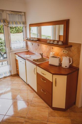 a kitchen with a sink and a counter top at Termálfürdő Apartman Igal -130 méterre a fürdőtől in Igal