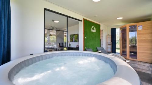 a large bath tub in a room at Villa Una by Villas Guide in Gornji Kneginec