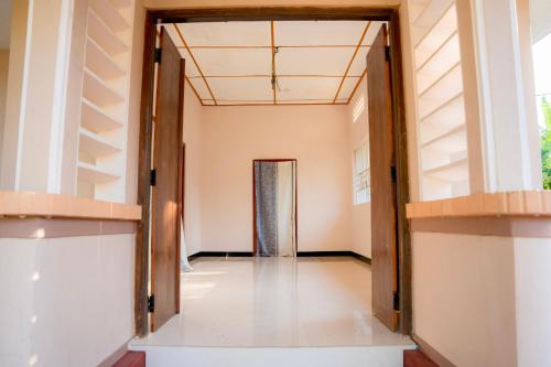 a hallway with an open door in a building at Naga Vasa in Jaffna