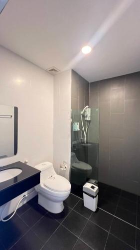 a bathroom with a toilet and a sink and a shower at The one residence in Ban Nong Phak Nam