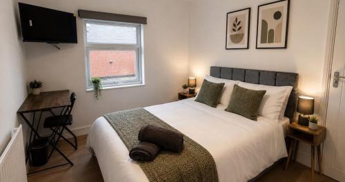a bedroom with a large white bed and a window at Contractor Workforce Accommodation - 5 Bedrooms Perfect For Work Crews & Groups, WiFi Smart TV's In All Rooms - Parking Sleeps 5-8 Guests in Kettering