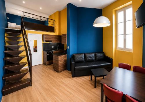 a living room with a dining room table and a loft bed at Les Appartements Carré d'or - Nice Centre in Nice