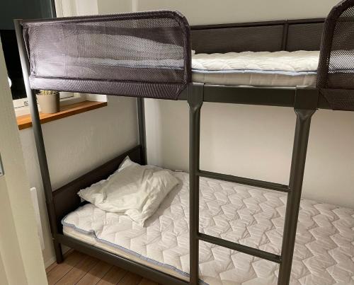 a bunk bed in a room with a pillow at Top Modern Holiday Home 100 M From The Baltic Sea in Nordborg