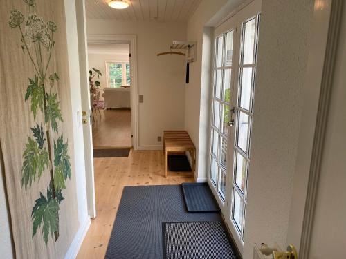a room with a hallway with a door and a rug at Idyllically Situated Wooden House By The Forest in Viborg