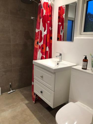 a bathroom with a sink and a shower curtain at Nice Summer House With Sea View in Jægerspris